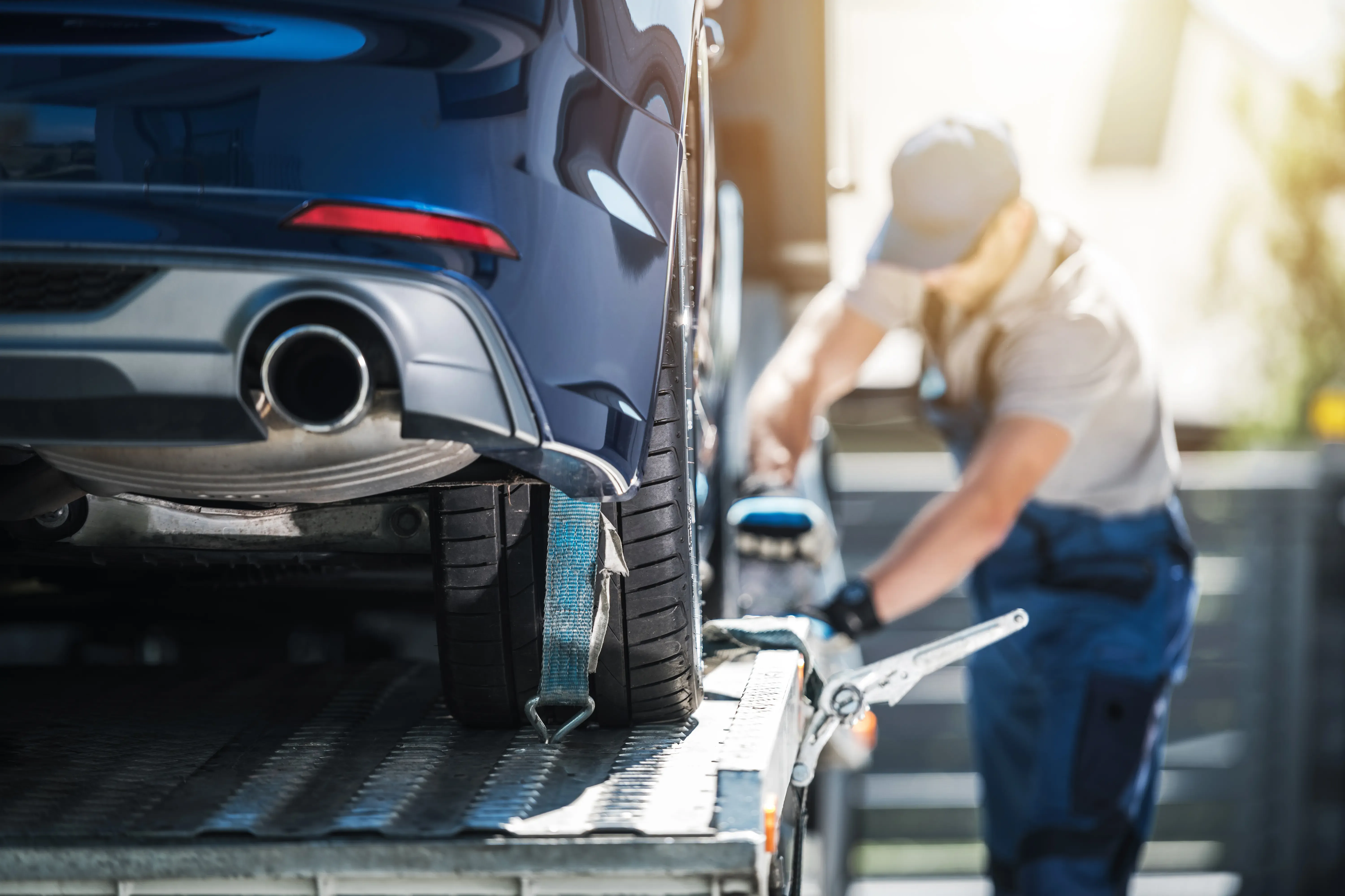 Driver loading up vehicles on an auto carrier
